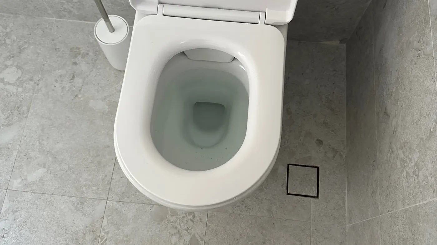 Tiled new-build bathroom in Carine with a square tile-insert floor waste beside the toilet