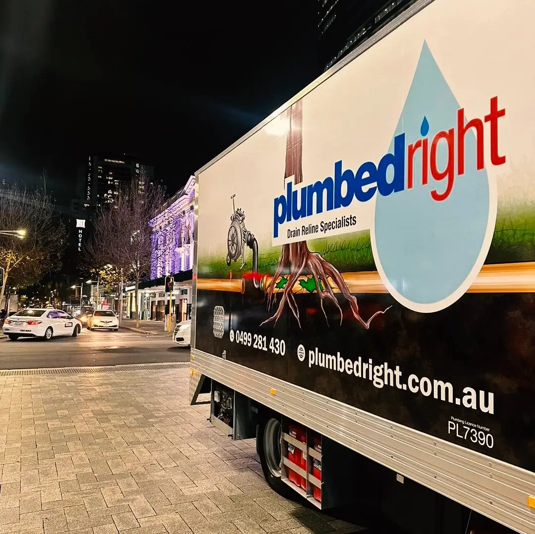 Plumbed Right navy truck at night in a city street