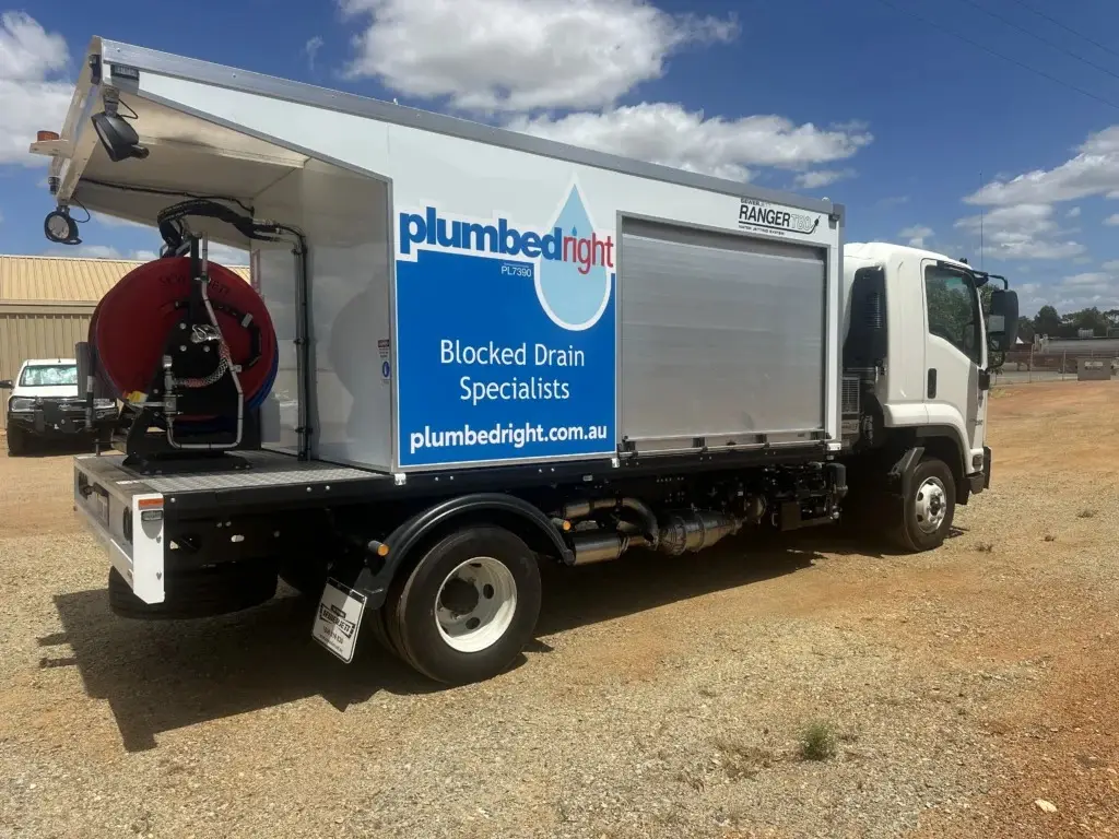 Plumbed Right jetter truck with the blue Blocked Drain Specialists panel