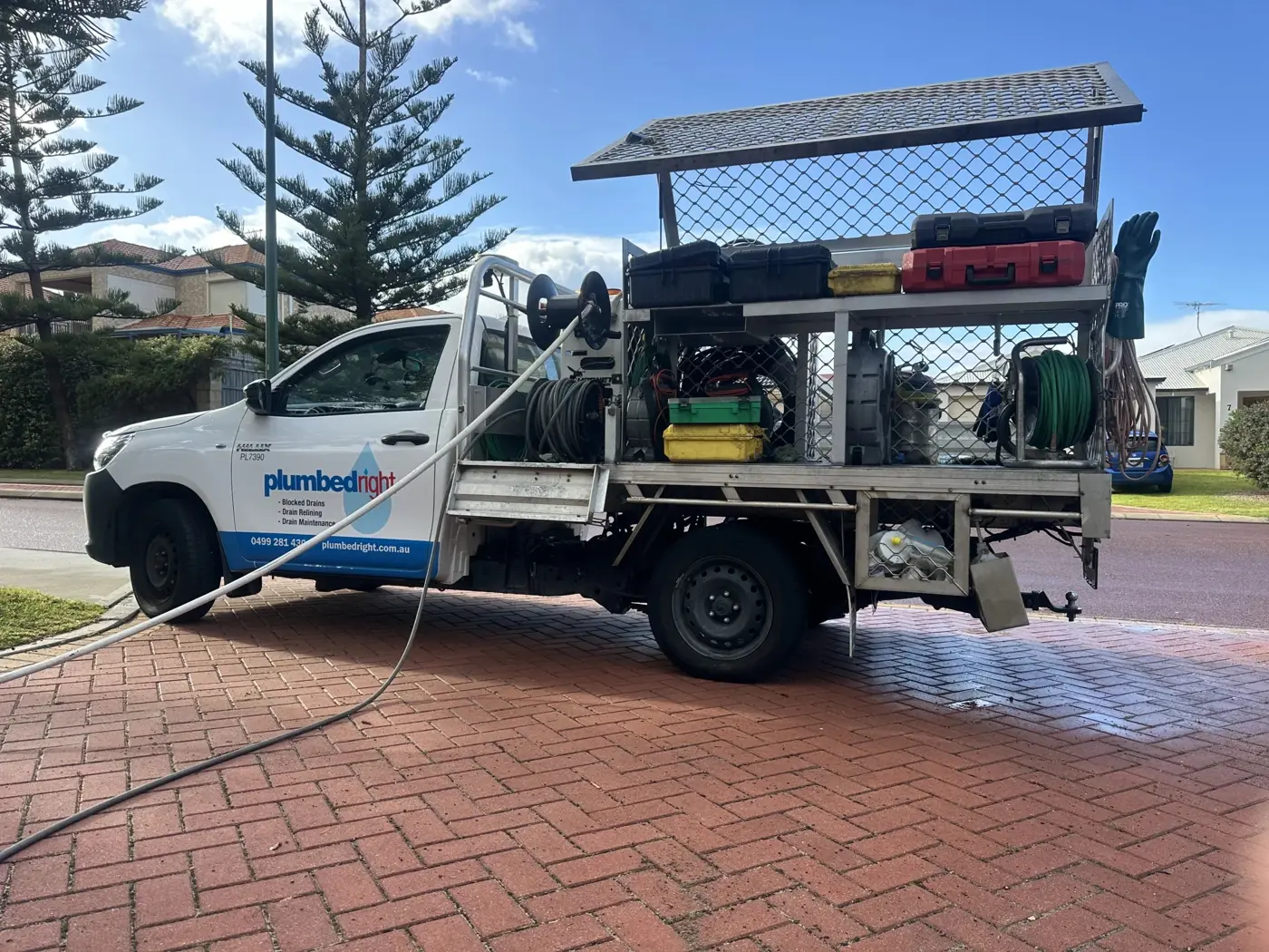 Plumbed Right ute on a brick-paved driveway